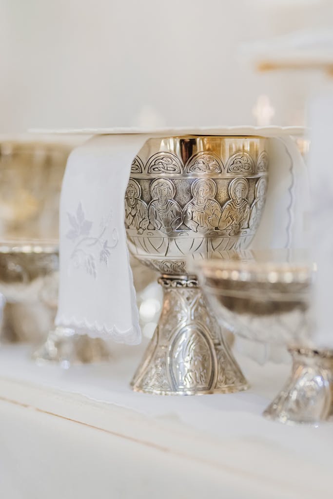 Close-up of an ornamental chalice used in Catholic liturgy, featuring intricate designs.