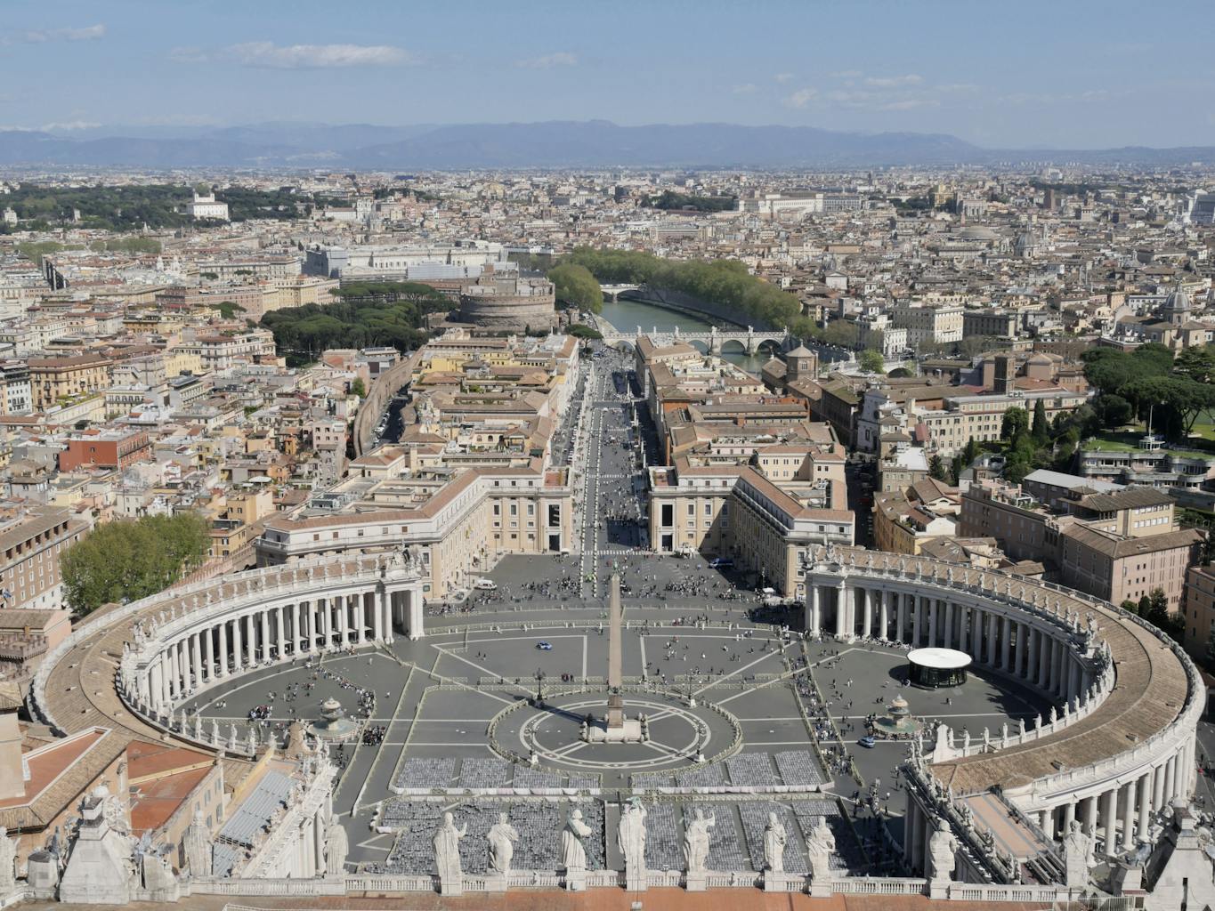 Panoramic aerial shot of St. Peter's Square in Vatican City, capturing the iconic elliptical colonnade.