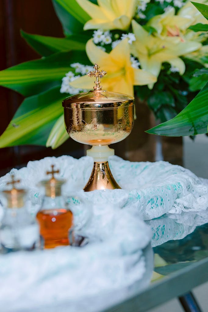 Gold chalice with floral backdrop, perfect for religious ceremonies and symbolic events.